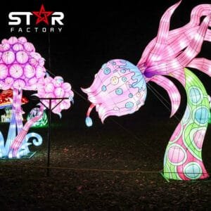 Goldfish lantern displayed among mushroom and garden lantern elements at night