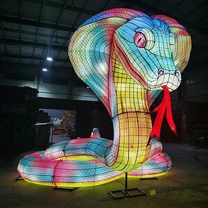 Cobra shaped lantern figure glowing with colorful patterned lighting