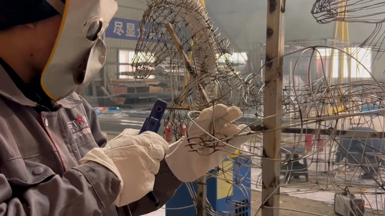 Artisan welding a custom lantern frame in the StarsLantern production workshop